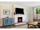 Comfortable living room featuring a brick fireplace and hardwood floors at 7350 W 21St Ave, Lakewood, CO 80214