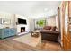 Cozy living room with a brick fireplace, hardwood floors, and a comfortable sofa at 7350 W 21St Ave, Lakewood, CO 80214