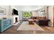 Inviting living room featuring a brick fireplace, wood floors, and a comfortable sofa at 7350 W 21St Ave, Lakewood, CO 80214