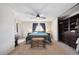 Comfortable bedroom with large window and a chest at the foot of the bed at 7705 W 87Th Dr, Arvada, CO 80005