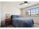 Bedroom with large window that brings in natural light and a ceiling fan at 7705 W 87Th Dr, Arvada, CO 80005