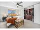 Bright bedroom features a ceiling fan, a window and a closet with custom built-ins at 7705 W 87Th Dr, Arvada, CO 80005