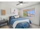 Comfortable bedroom with a window, featuring a bed with a blue quilt at 7705 W 87Th Dr, Arvada, CO 80005