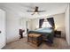 Bright bedroom with a large window, neutral carpet, and a ceiling fan at 7705 W 87Th Dr, Arvada, CO 80005