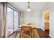 Bright dining area with wood table, bench, and sliding glass door at 7705 W 87Th Dr, Arvada, CO 80005