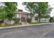 Inviting condo complex entrance with mature trees and a community pool in the background at 7705 W 87Th Dr, Arvada, CO 80005