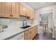 Modern kitchen features bright cabinets, white countertops, and stainless steel sink at 7705 W 87Th Dr, Arvada, CO 80005