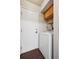 The laundry room features a white washer and dryer, cabinet storage, and an exterior access door at 7705 W 87Th Dr, Arvada, CO 80005