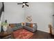 Cozy living room with vaulted ceiling, hardwood floors, and comfortable sectional sofa at 7705 W 87Th Dr, Arvada, CO 80005