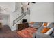 Spacious living room with staircase, hardwood floors, and open layout at 7705 W 87Th Dr, Arvada, CO 80005