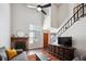 Bright living room featuring a fireplace, tall windows, and an open staircase at 7705 W 87Th Dr, Arvada, CO 80005