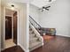 Open-concept living space with hardwood floors, staircase and comfortable seating at 7705 W 87Th Dr, Arvada, CO 80005