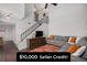 Inviting living room with neutral walls, modern staircase, and stylish decor creates a comfortable and appealing space at 7705 W 87Th Dr, Arvada, CO 80005