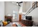 Inviting living room featuring a fireplace, a high ceiling with a ceiling fan, and a staircase at 7705 W 87Th Dr, Arvada, CO 80005