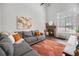 Stylish living room featuring a stone fireplace, ample natural light, and comfortable seating for relaxation at 7705 W 87Th Dr, Arvada, CO 80005