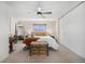 Bright main bedroom with ceiling fan, closet, and serene decor at 7705 W 87Th Dr, Arvada, CO 80005