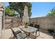 Outdoor patio features an umbrella, seating, and a hammock strung between trees at 7705 W 87Th Dr, Arvada, CO 80005