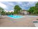 Spacious community pool area offering ample seating and mature trees and landscaping at 7705 W 87Th Dr, Arvada, CO 80005