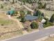 Stunning aerial view of the ranch style home, barn, and surrounding acreage at 12160 Spring Creek Rd, Parker, CO 80138