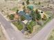 Aerial view of a well-maintained home surrounded by lush landscaping and an asphalt driveway at 12160 Spring Creek Rd, Parker, CO 80138