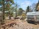 Spacious backyard with a greenhouse, mature trees, and a fenced perimeter at 12160 Spring Creek Rd, Parker, CO 80138