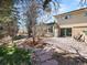Inviting backyard featuring a patio, lush greenery, and mature landscaping at 12160 Spring Creek Rd, Parker, CO 80138
