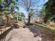 Picturesque backyard with a stone patio, mature trees, and landscaped surroundings at 12160 Spring Creek Rd, Parker, CO 80138
