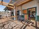 An interior shot highlights a barn's enclosure with a metal roof, wooden supports, and an open doorway at 12160 Spring Creek Rd, Parker, CO 80138