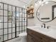 Modern bathroom featuring glass shower, a vanity, and decorative shelving at 12160 Spring Creek Rd, Parker, CO 80138