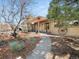 A stone pathway leads to a house with pergola covered patio at 12160 Spring Creek Rd, Parker, CO 80138