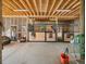 An interior view of stalls with wood and steel construction and overhead lighting at 12160 Spring Creek Rd, Parker, CO 80138