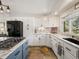 Well-lit kitchen with stone countertops, stainless steel appliances, and plenty of storage at 12160 Spring Creek Rd, Parker, CO 80138