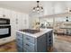 Spacious kitchen with a gray island, modern appliances, and abundant natural light at 12160 Spring Creek Rd, Parker, CO 80138
