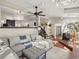 Open concept living room featuring a large sectional sofa, brick accents and plenty of natural light at 12160 Spring Creek Rd, Parker, CO 80138