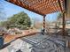 Outdoor patio area with a stylish pergola, outdoor rug, and serene garden with a water feature at 12160 Spring Creek Rd, Parker, CO 80138