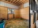 Horse stall with wood paneling, ample space, and a window offering natural light at 12160 Spring Creek Rd, Parker, CO 80138