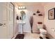 Cozy half bathroom with a pedestal sink, modern fixtures, and soft lighting at 13626 Garfield St # A, Thornton, CO 80602