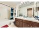 Functional bathroom featuring a double sink vanity and shower-tub combination at 13626 Garfield St # A, Thornton, CO 80602