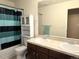 Functional bathroom with double sinks, tiled countertop, vanity, and a shower-tub combination at 13626 Garfield St # A, Thornton, CO 80602