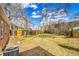Spacious backyard with mature trees and partial fencing is ready for landscaping and entertaining at 1448 Newport St, Denver, CO 80220