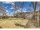 Fenced backyard features mature trees and a storage shed, providing space and privacy at 1448 Newport St, Denver, CO 80220
