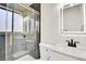 Modern bathroom features a glass-enclosed shower, decorative tile, and contemporary fixtures at 1448 Newport St, Denver, CO 80220