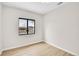 Clean bedroom with modern hardwood floors and a large window at 1448 Newport St, Denver, CO 80220