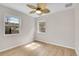 Bright bedroom with wood-look floors, neutral walls, ceiling fan, and natural light at 1448 Newport St, Denver, CO 80220