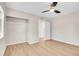 Bright bedroom featuring wood-look floors, neutral walls, ceiling fan, and a closet at 1448 Newport St, Denver, CO 80220