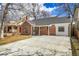 Charming brick home featuring a covered entrance and a long concrete driveway, ideal for a Gathering at 1448 Newport St, Denver, CO 80220