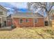 Back exterior view of home with brick facade, AC unit and windows at 1448 Newport St, Denver, CO 80220