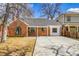 Charming brick home with a concrete driveway and manicured lawn, perfect for suburban living at 1448 Newport St, Denver, CO 80220