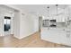 Modern kitchen with white cabinets, stainless steel appliances, and an island with pendant lighting at 1448 Newport St, Denver, CO 80220
