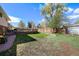Expansive backyard with a spacious deck, mature tree, and potential for outdoor activities and entertaining at 2009 S Zephyr Ct, Lakewood, CO 80227